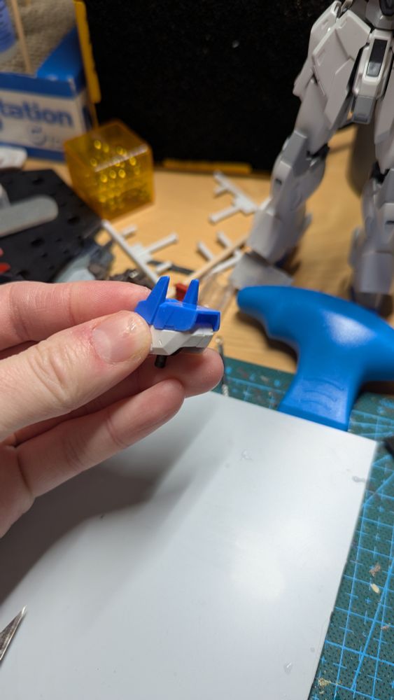 Blue and white shoulder piece being held