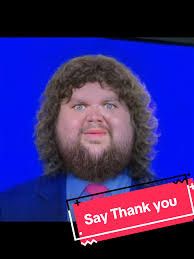 An unattractive photo depiction of pudgy-faced, long haired, bearded, useless VP Vance. A red sign that says, “Say Thank you” (his loud and rude Oval Office comment to President Zelenskyy) is below his hideous face.