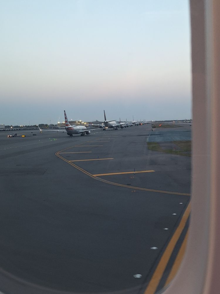 A queue of about 20 planes at JFK taxiing for takeoff