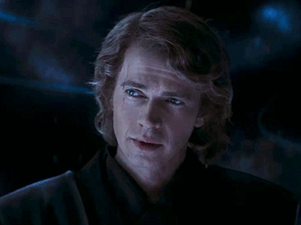 a close up of a man 's face in a dark room in a star wars movie .