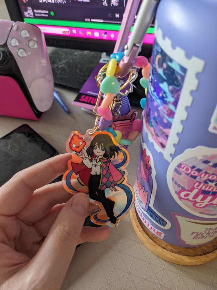 One side of the keychain has blond Howl. The opposite side has black haired Howl