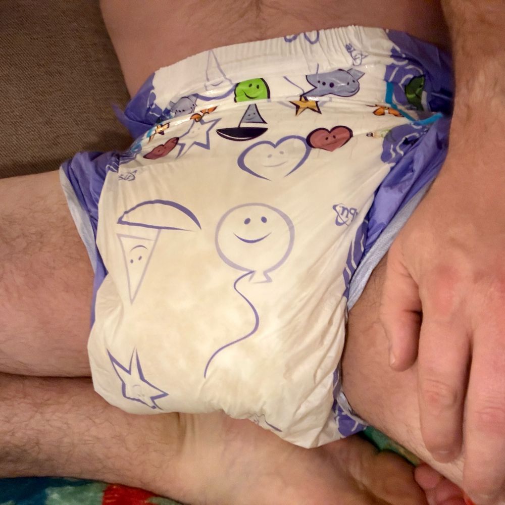 A boy wearing a soaked abu cushies diaper