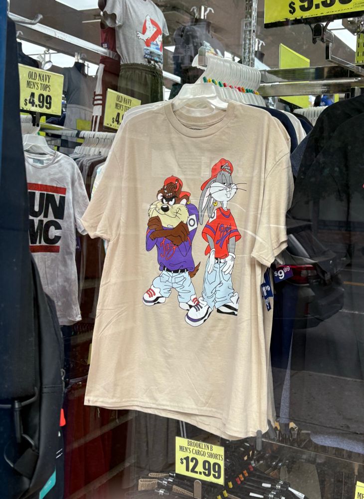 Store window with a 90s-ass “gangsta” Looney Tunes shirt with Taz and Bugs in streetwear