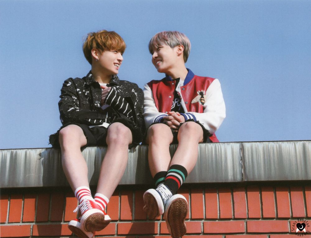 you never walk alone hopekook. They're sitting side by side on a roof, it's as sunny day, their shoulders are touching, & they're smiling at each other. (ctto - credit on pic)