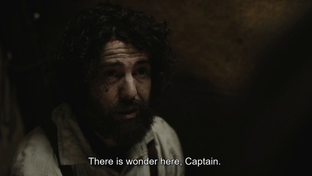Scene from Episode 10 "We Are Gone".

We're in Dr. Goodsir's tent at Hickey's Cannibal Camp. Goodsir speaks to Captain Crozier for the last time.
Closed caption reads, "There is wonder here, Captain."