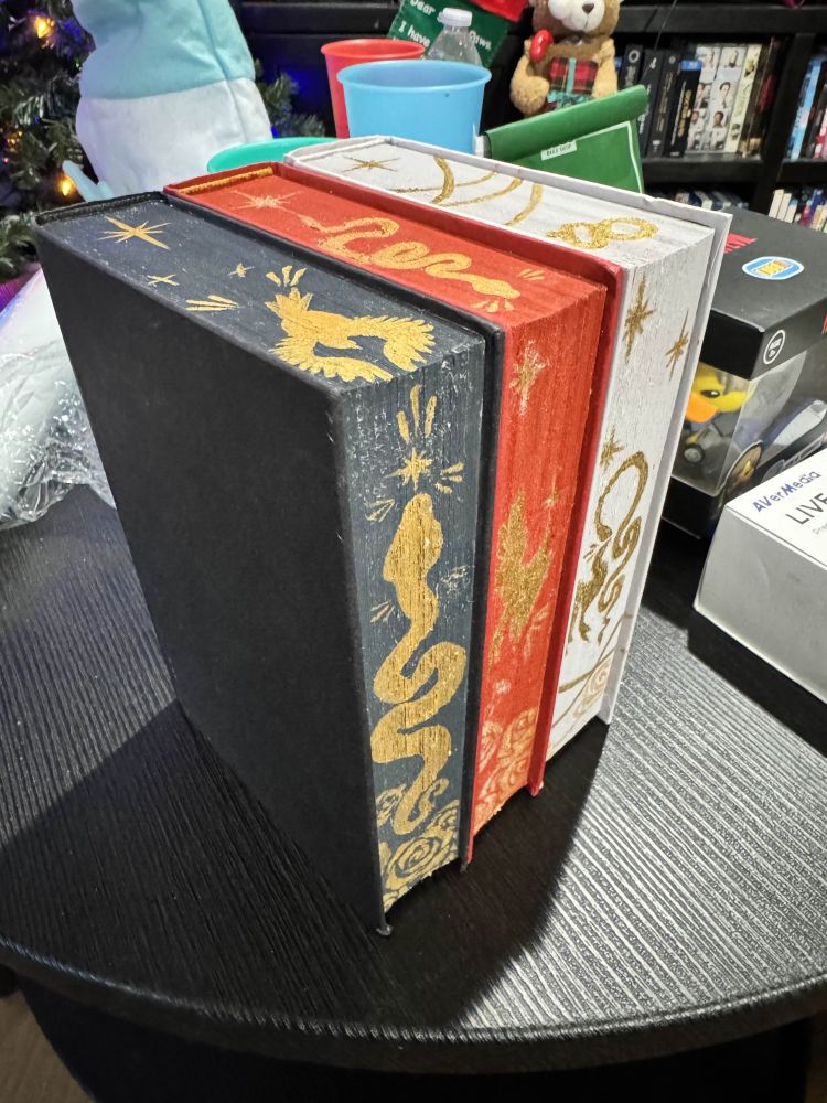 All 3 books in the Serpent & Dove trilogy with custom painted pages along all sides.