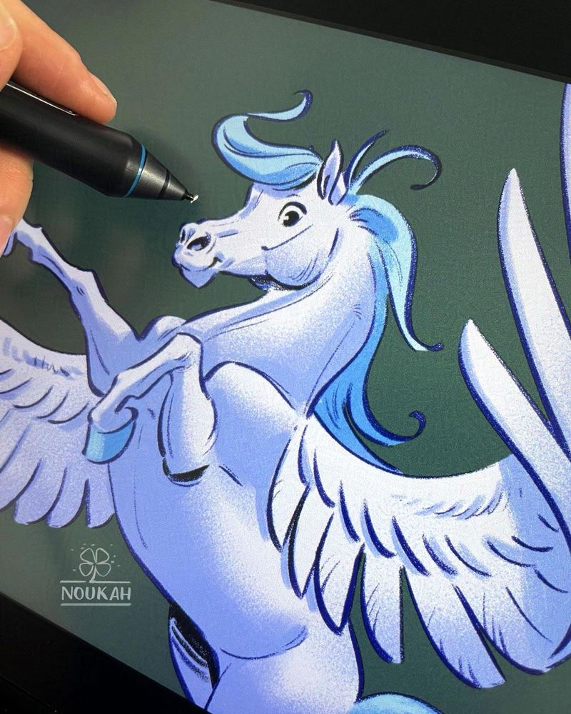 Photo of my drawing tablet and hand working on a pegasus illustration in a comic book style.
