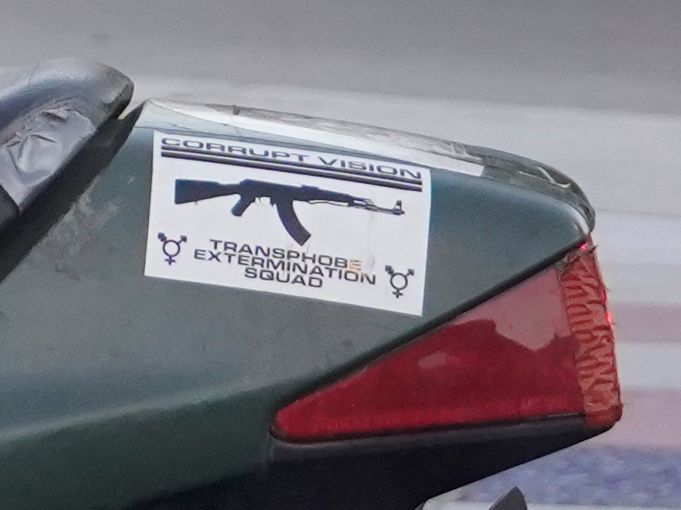 a sticker on the back of the bike that says "transphobe extermination squad" 
