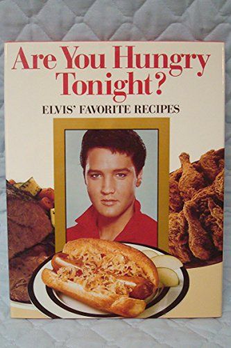 Elvis in a red shirt in front of a chili dog, a roast, and fried chicken. 