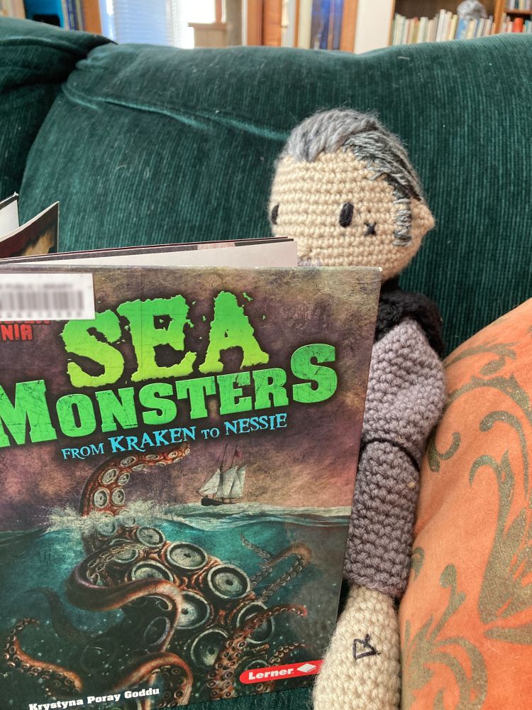 Izzy reads "Sea Monsters: From Kraken to Nessie"