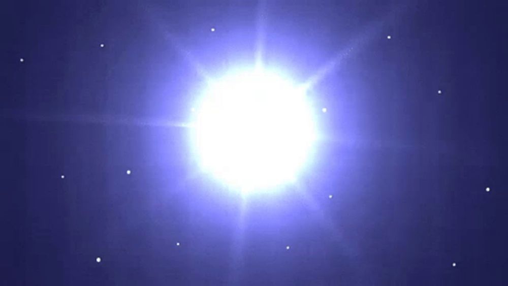 a bright white star is surrounded by smaller stars in a blue sky