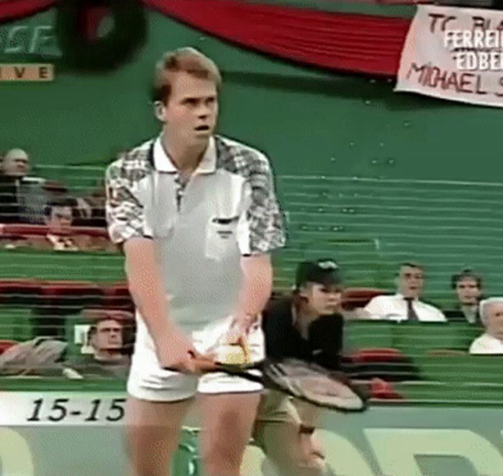 a man is holding a tennis racquet in front of a banner that says 15-18