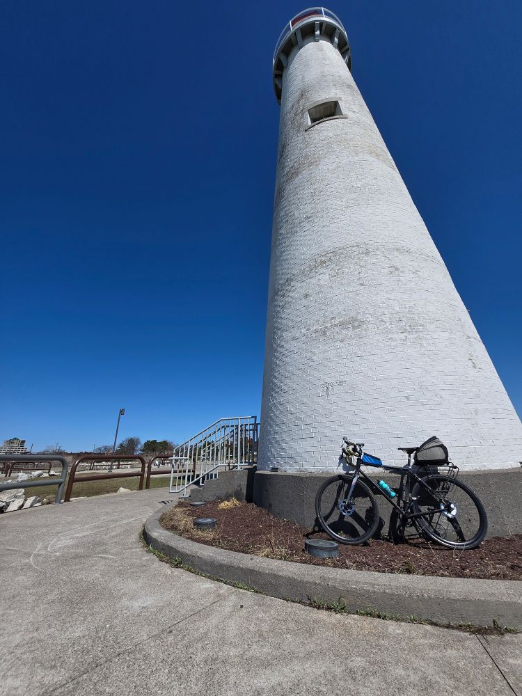 A bicycle in front of a white lighthouse