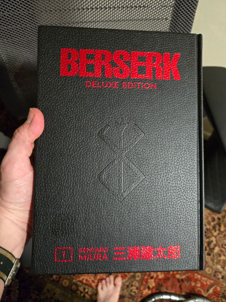 Volume 1 of the Berserk Deluxe Edition with its red-on-black cover