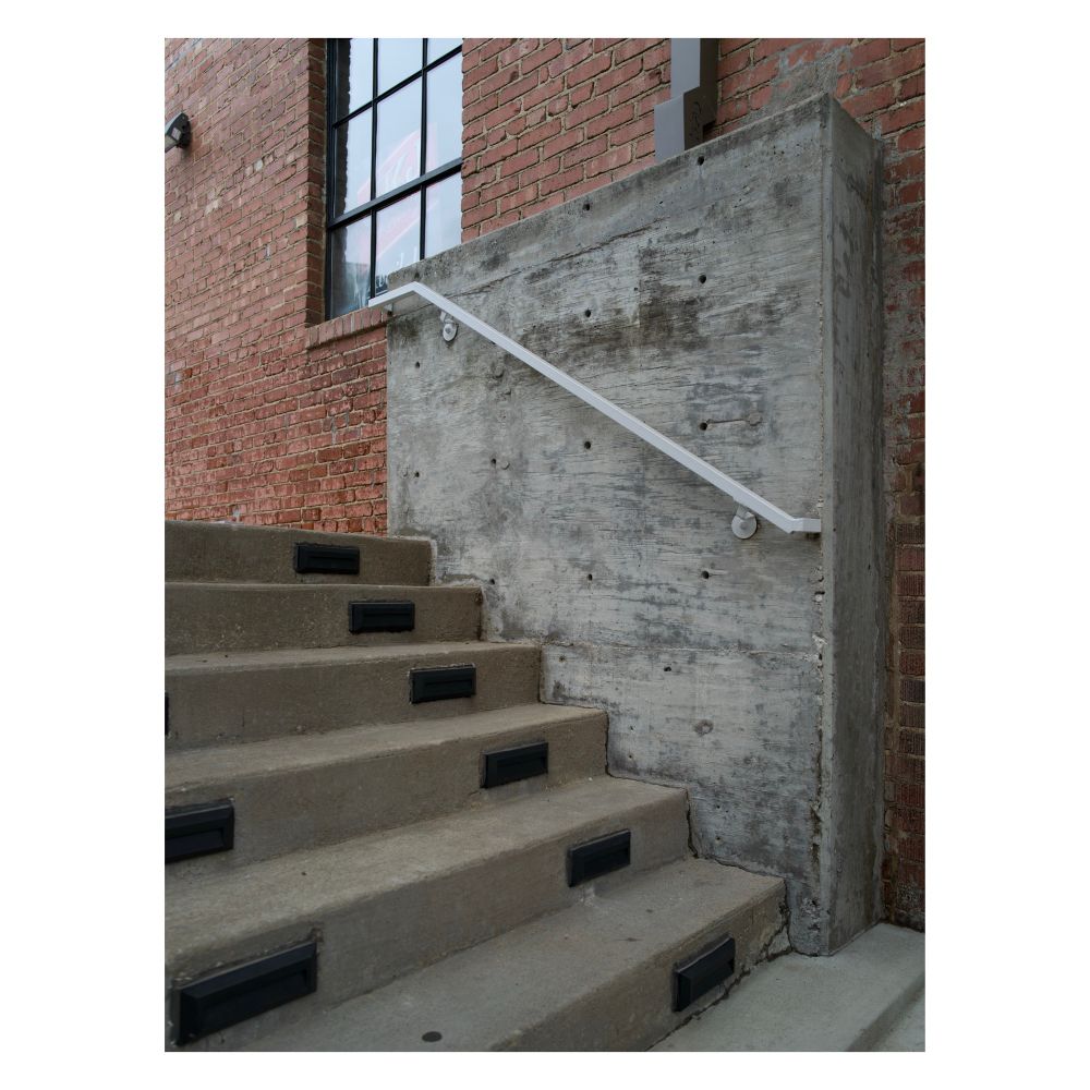 Photo of concrete steps next to a brick wall