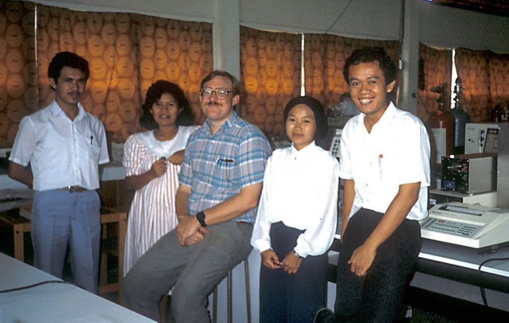 A diverse group of five scientists in a lab in Borneo, Indonesia. Copyright Tom Kimmerer