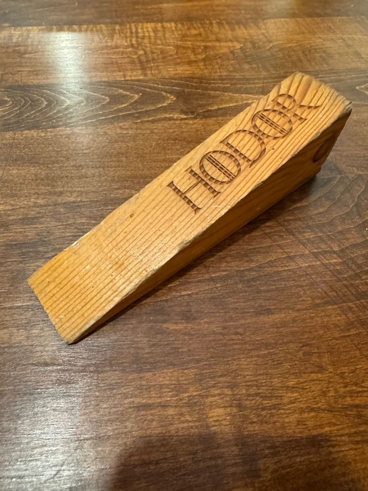A door wedge with the name “Hodor” engraved into it.