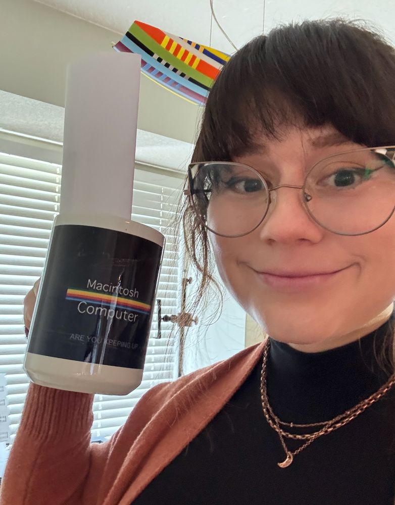 a Lady holding a mug that says "Macintosh computer" on it!