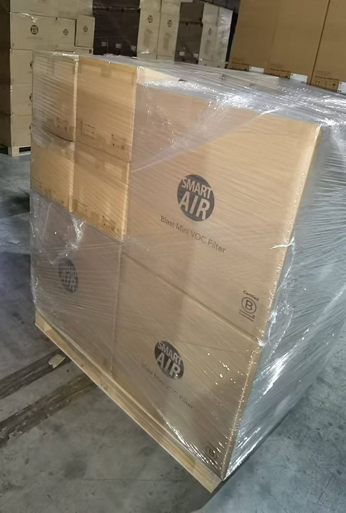 Shrink-wrapped pallet with stacked cardboard boxes labeled 'Smart Air' ready for shipment.