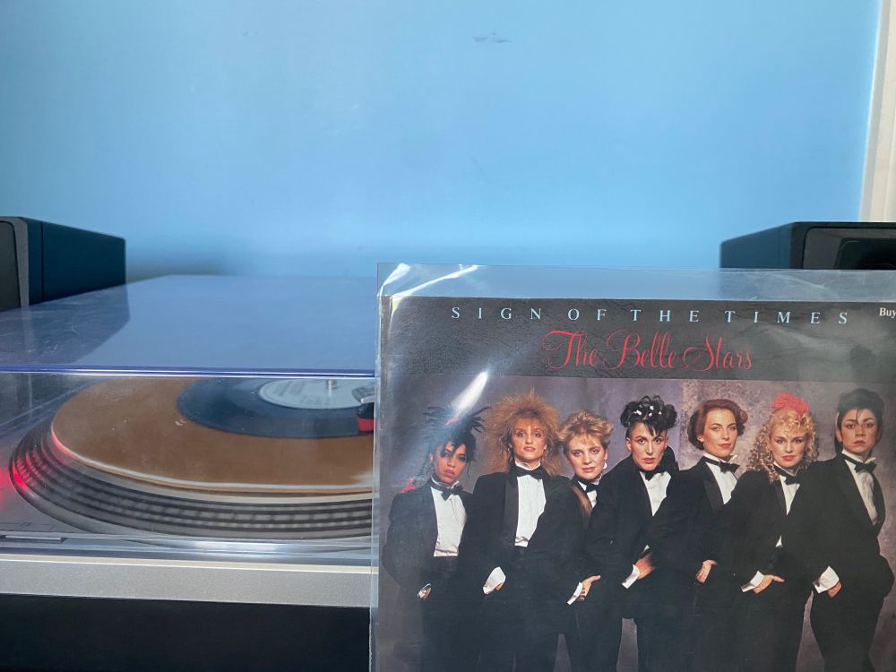 7" record of "Sign of the Times" by The Belle Stars spinning on a record player