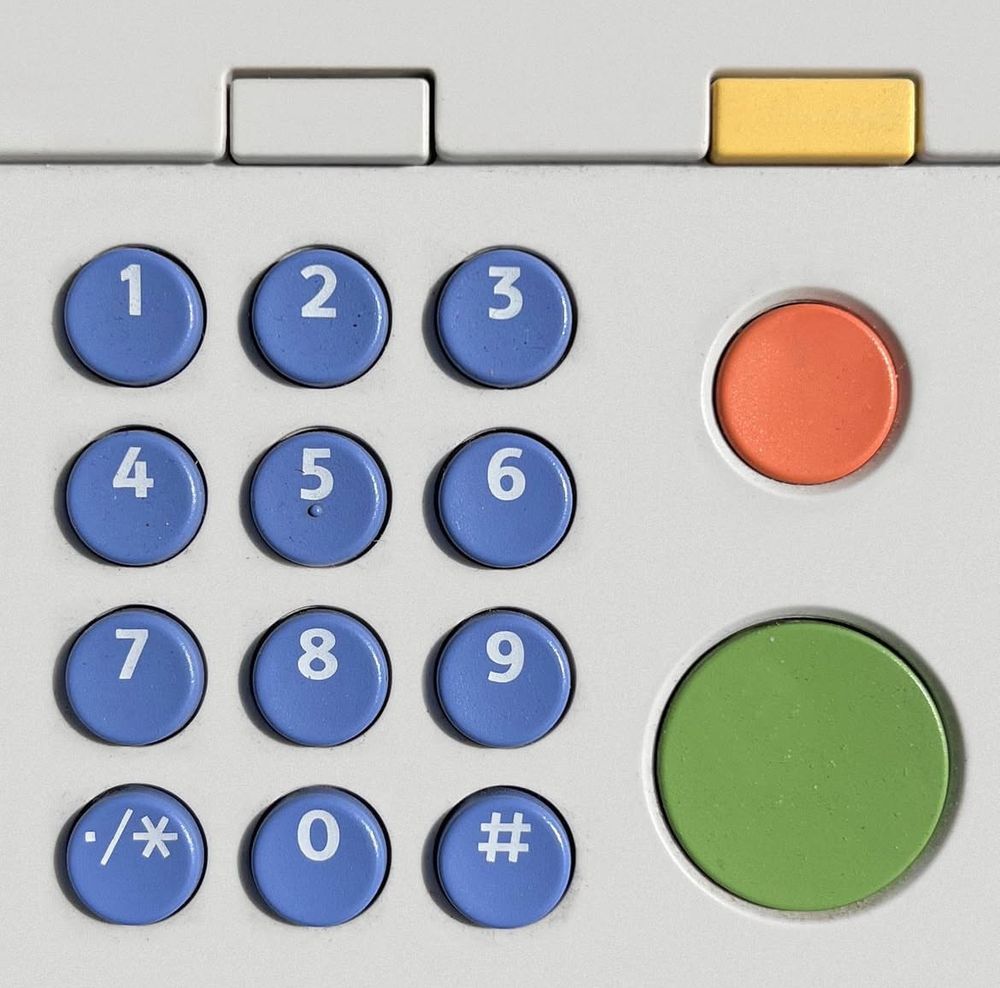 A pale grey background has circular buttons in orange green and blue 