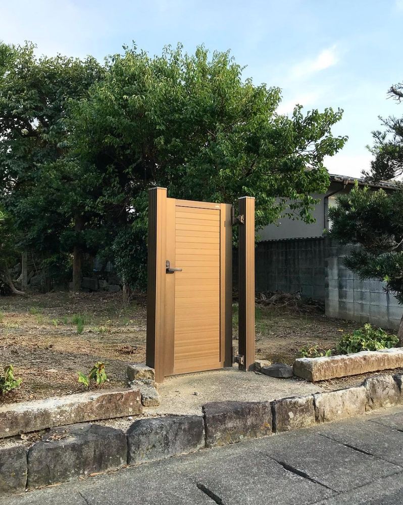a door stands alone, leading into a garden which has no fence or wall so it is already accessible from all angles. 