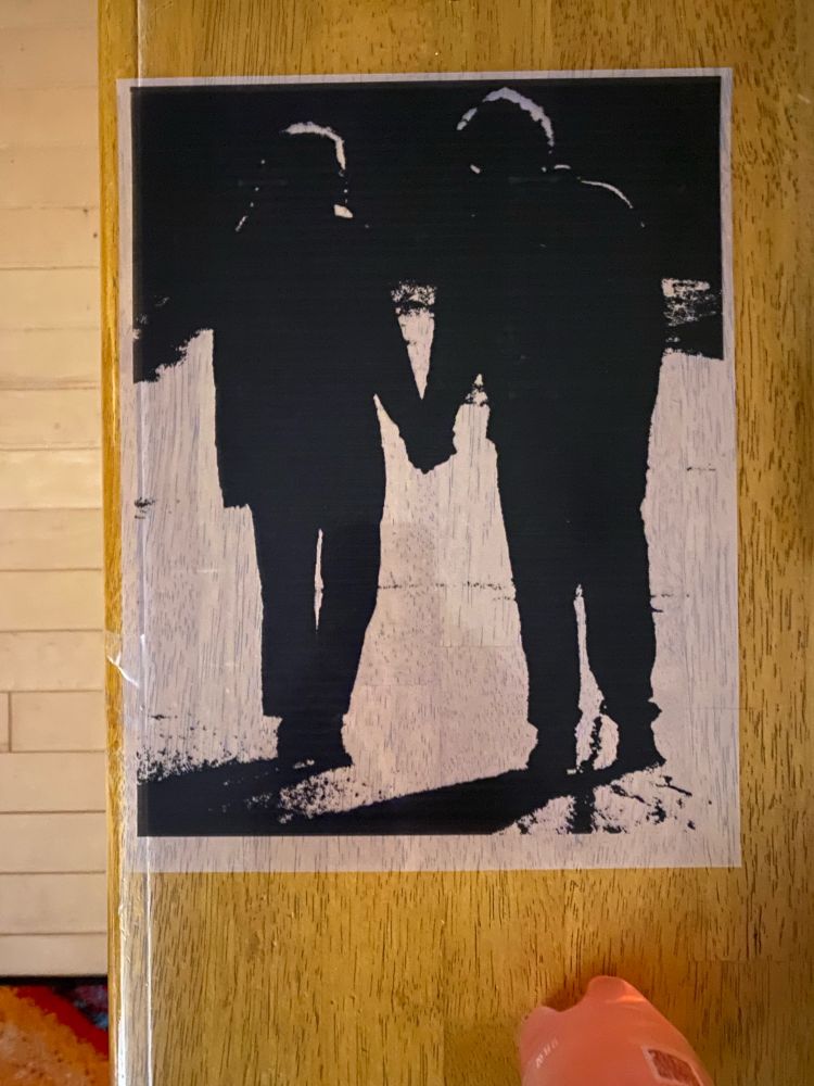 Screen print design of two people holding hands.