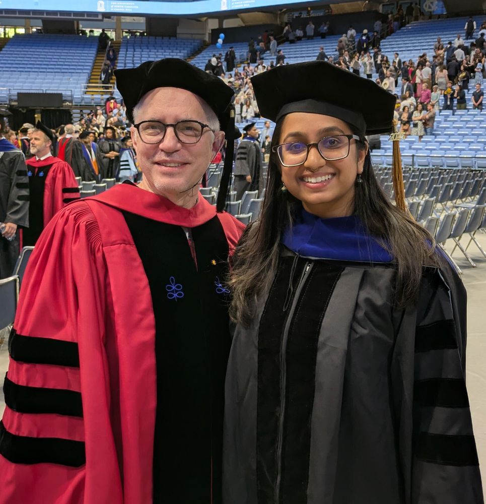 Dr. Nila Pazhayam in her doctoral gown and hood, accompanied by her advisor Jeff Sekelsky