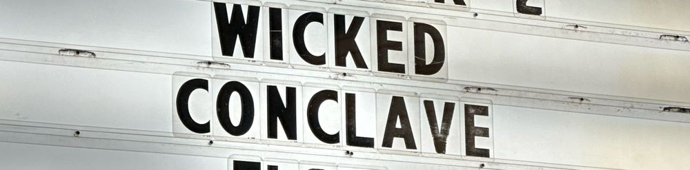 A movie marquee that reads 
“WICKED
CONCLAVE”