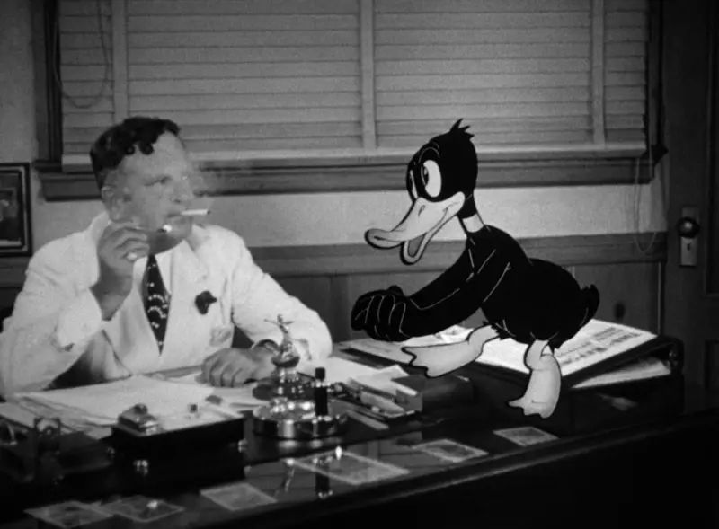 Daffy Duck asks producer Leon Schlesinger for a contract.