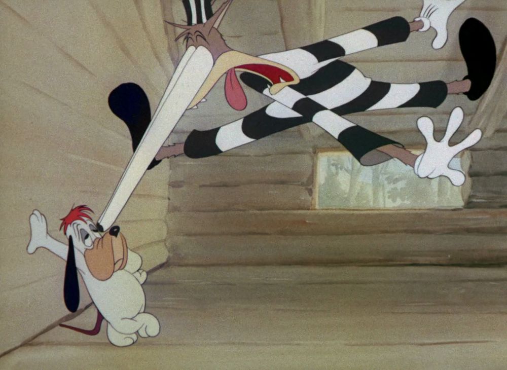The Killer is up in the air, arms and legs flailing, as his eyes bulge out of his head in shock at the sight of Droopy. Droopy casually leans against the wall.