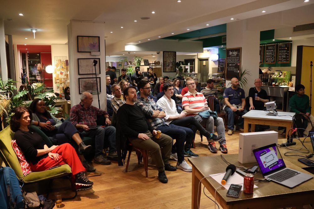 Event attendees watching a speaker deliver a talk