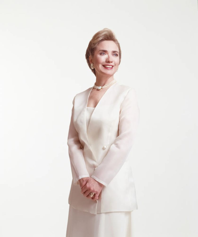 Photo of the brilliant and beautiful Hillary Rodham Clinton smiling sweetly whilst wearing a pearl white suit and a unique pearl necklace. Photo credit: Michael O'Neil, NYT, 1993