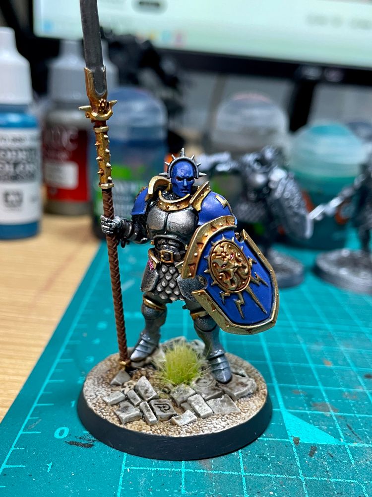 Stormcast miniature with green grass on the base