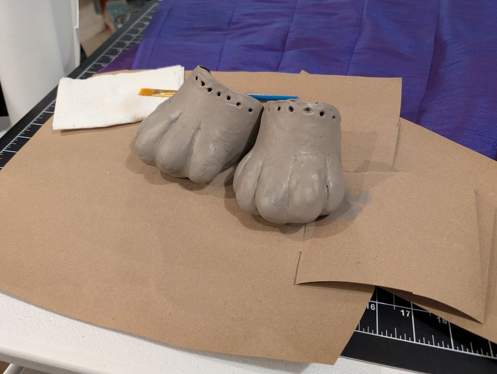 Picture of foam clay cat feet painted grey-brown with acrylic paint 