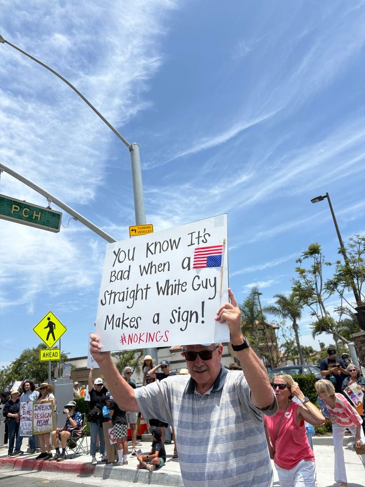 Old white man holding sign saying, “You know it’s bad when a straight white guy makes a sign! #NoKings”