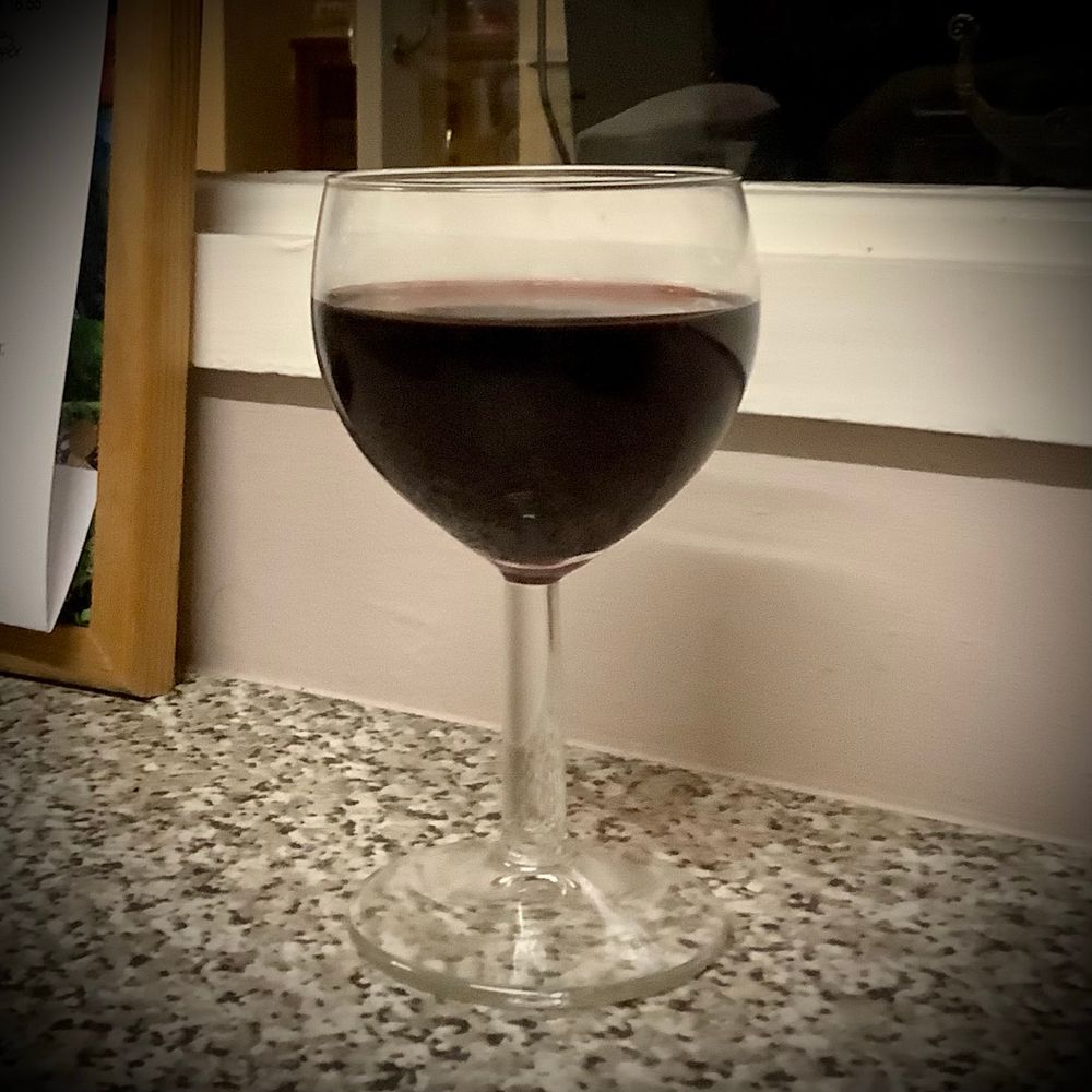 Rather smeary glass of red wine.