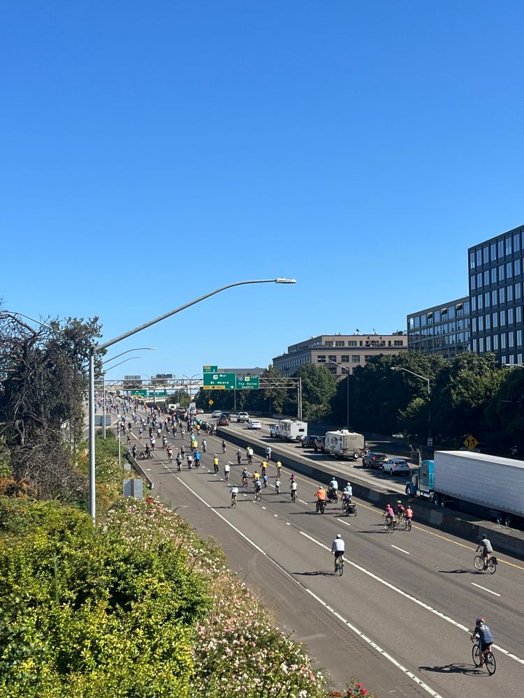 Hundreds of people biking on the interstate, which is closed to traffic because it’s good to close roads for lots of people to cycle and is definitely not a war zone. 