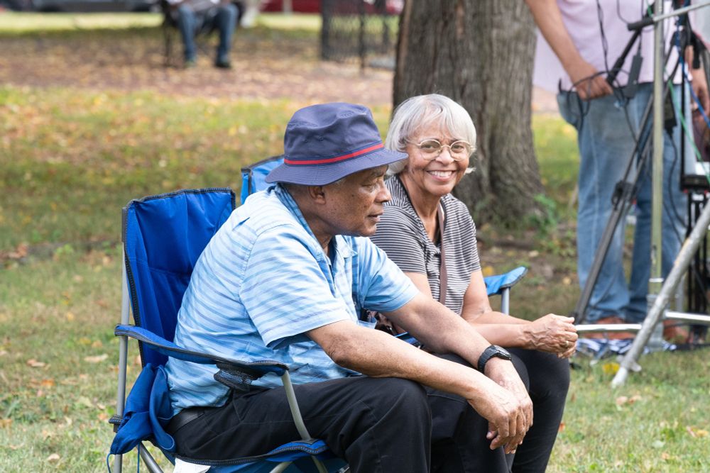 Two audience members smiling