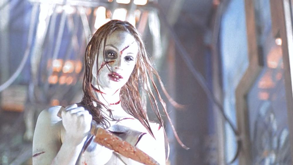 The angry princess from Thirteen Ghosts. A pale scared woman carrying a butcher knife