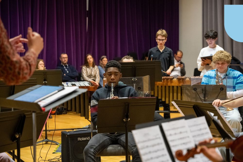 A group of young disabled and non-disabled musicians rehearse together.
