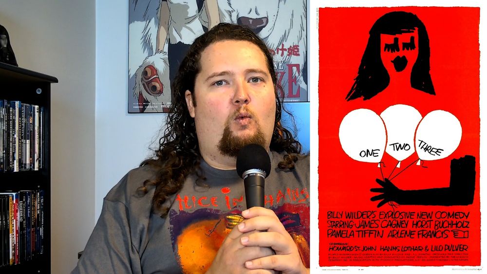 Daniel making a dumb face next to the poster for Billy Wilder's One Two Three.