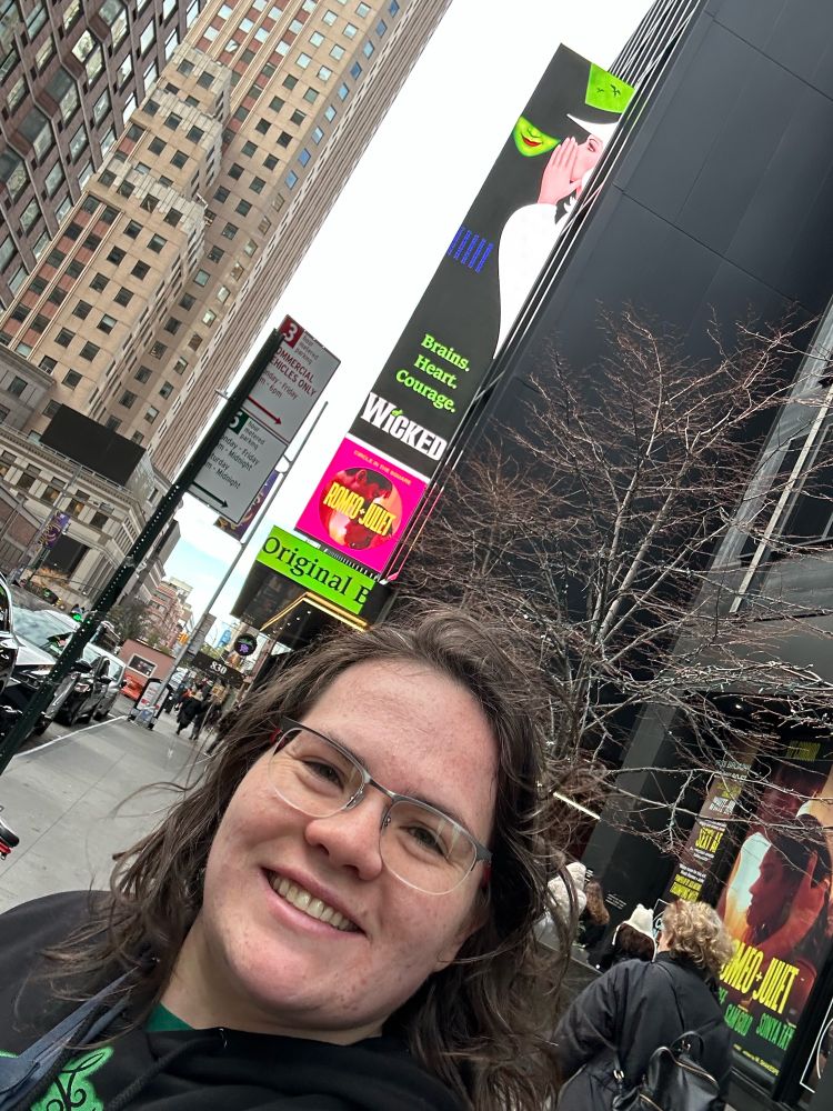 Woman in front of Wicked Marquee.