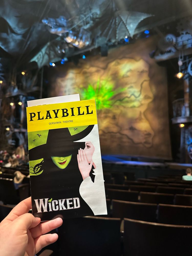 Playbill for Wicked in front of its stage.