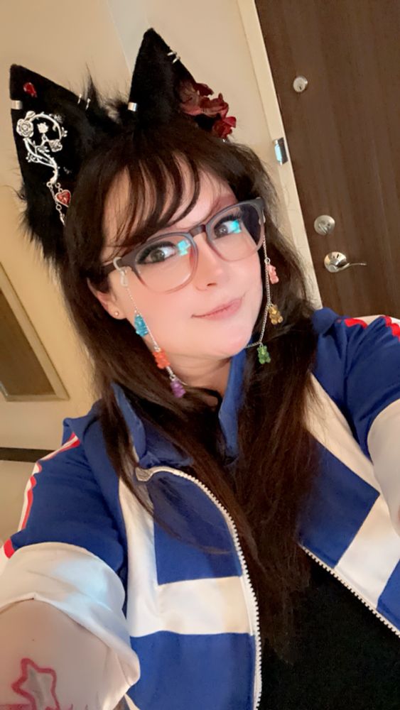 Image shows myself. A white woman with brown hair and black fox ears 