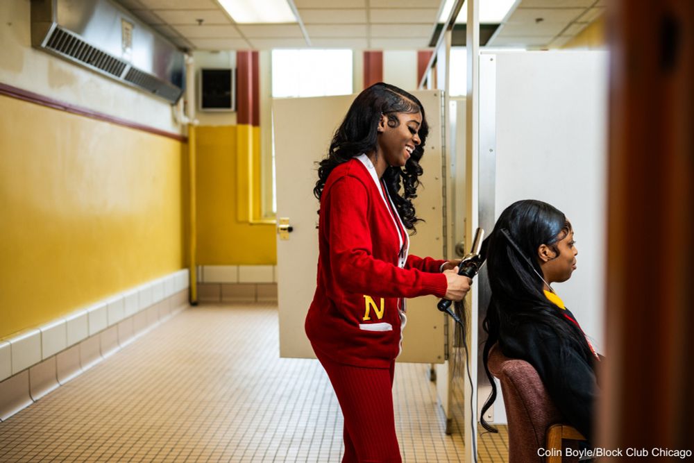 Jessica Thurmond, a student at North Lawndale College Prep, curls her classmate Jada Ervin’s hair at school on March 18, 2025. Credit: Colin Boyle/Block Club Chicago
