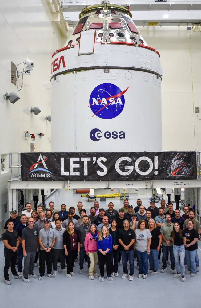 The Artemis II Orion Spacecraft shortly after being readied for its move to the LASF. NASA engineers and technicians pose in front of their spacecraft. This Orion will be the first NASA spacecraft to carry crew into space since Atlantis flew for the final time in 2011.