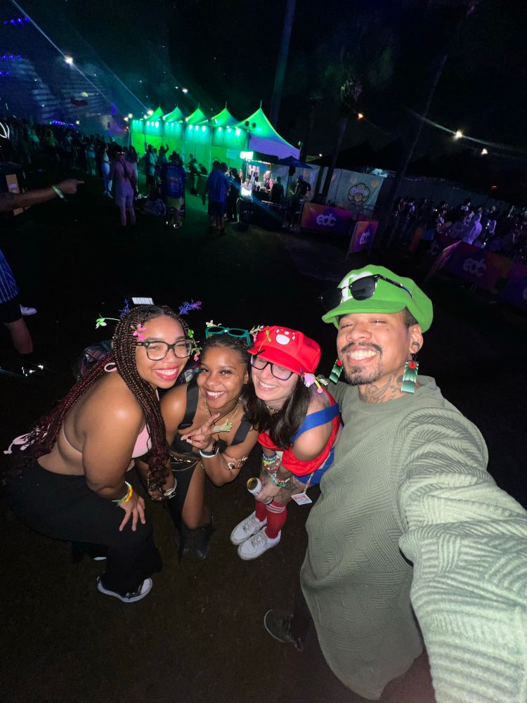 A selfie of @MissyMelliott, her boyfriend, and two girl friends smiling at EDCO