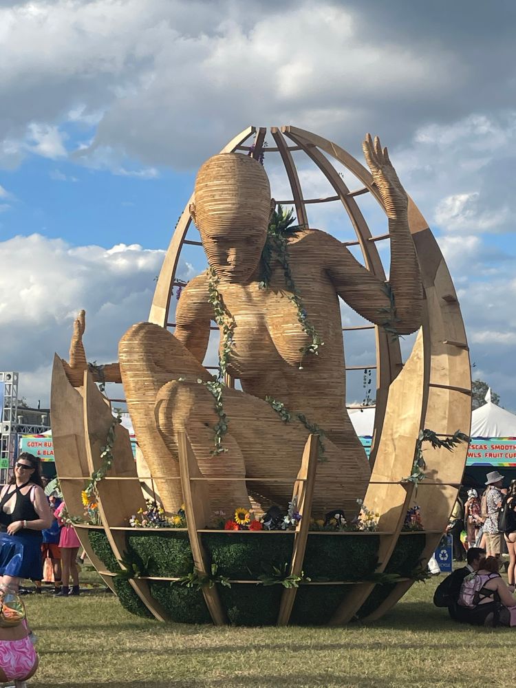 A giant wooden sculpture of a naked woman