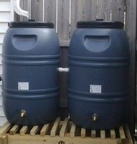 Two black rain barrels.